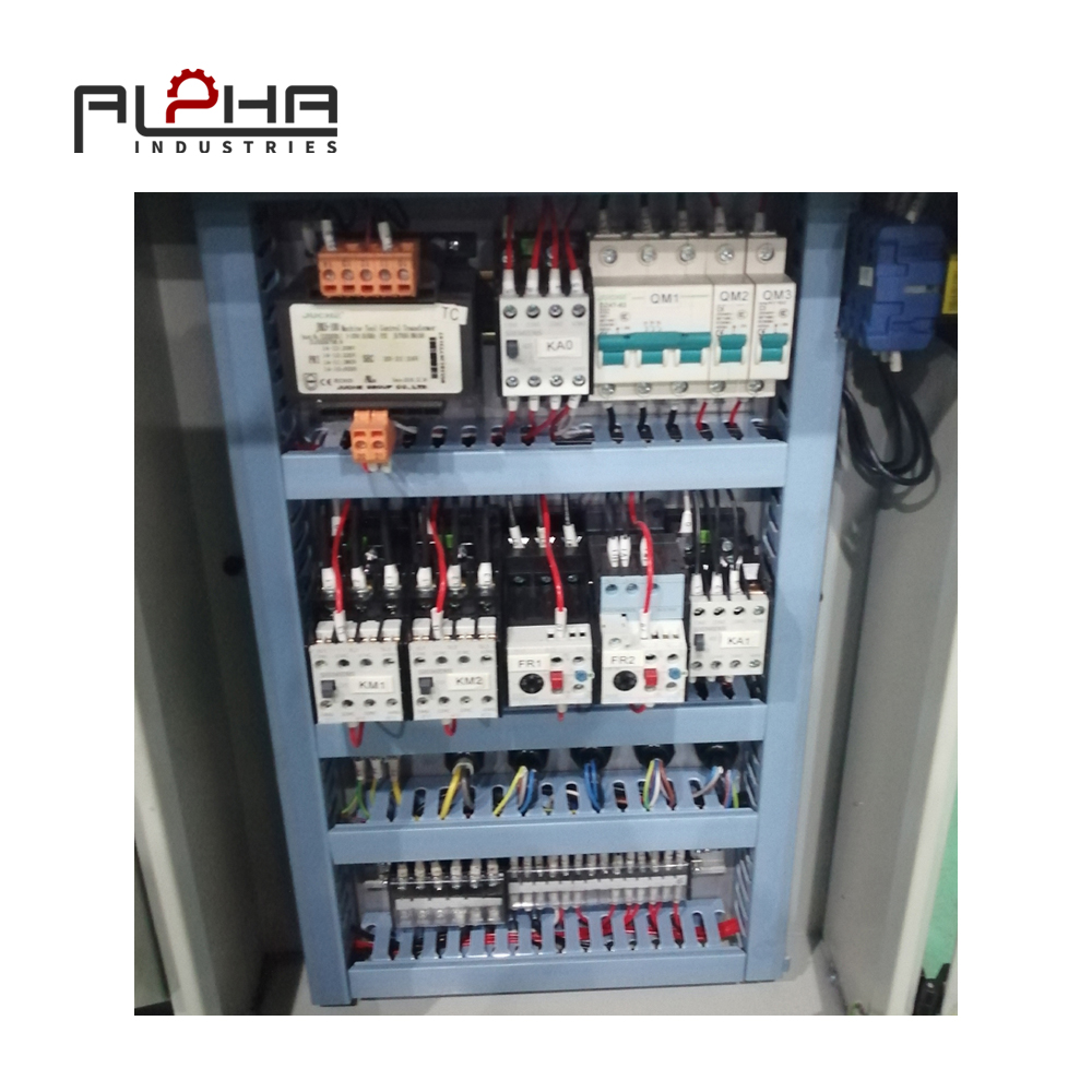 Person standing in a factory with machinery in the background