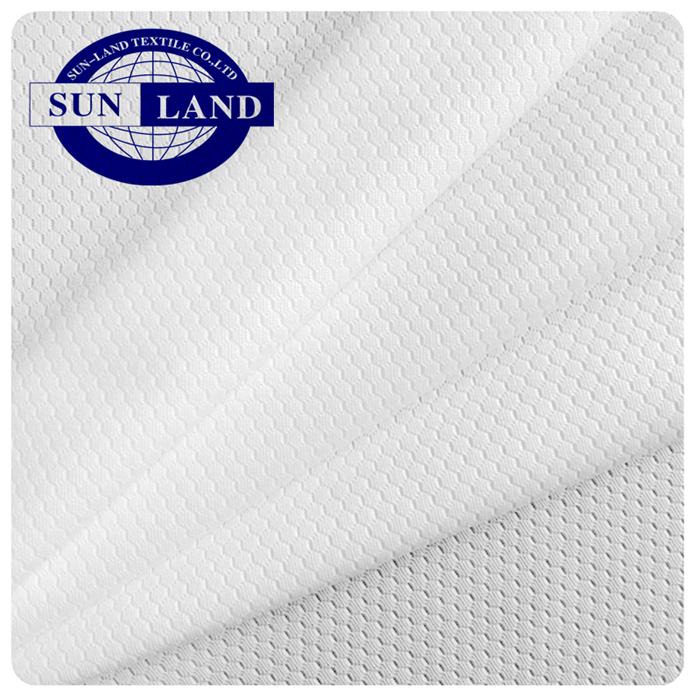 Person standing in a factory with machinery in the background