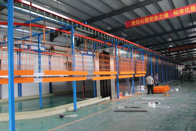 Person standing in a factory with machinery in the background