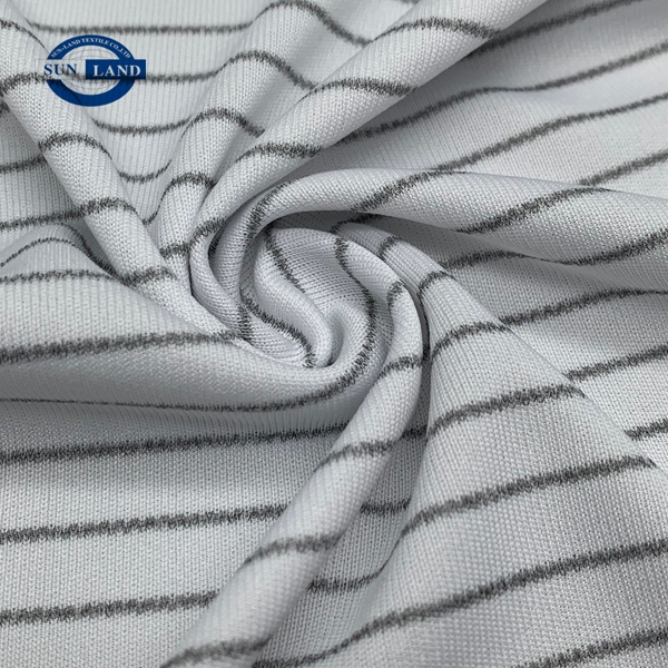 Person standing in a factory with machinery in the background