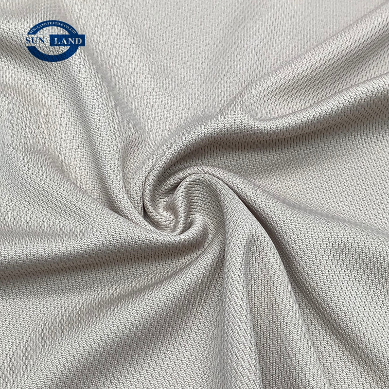 Person standing in a factory with machinery in the background