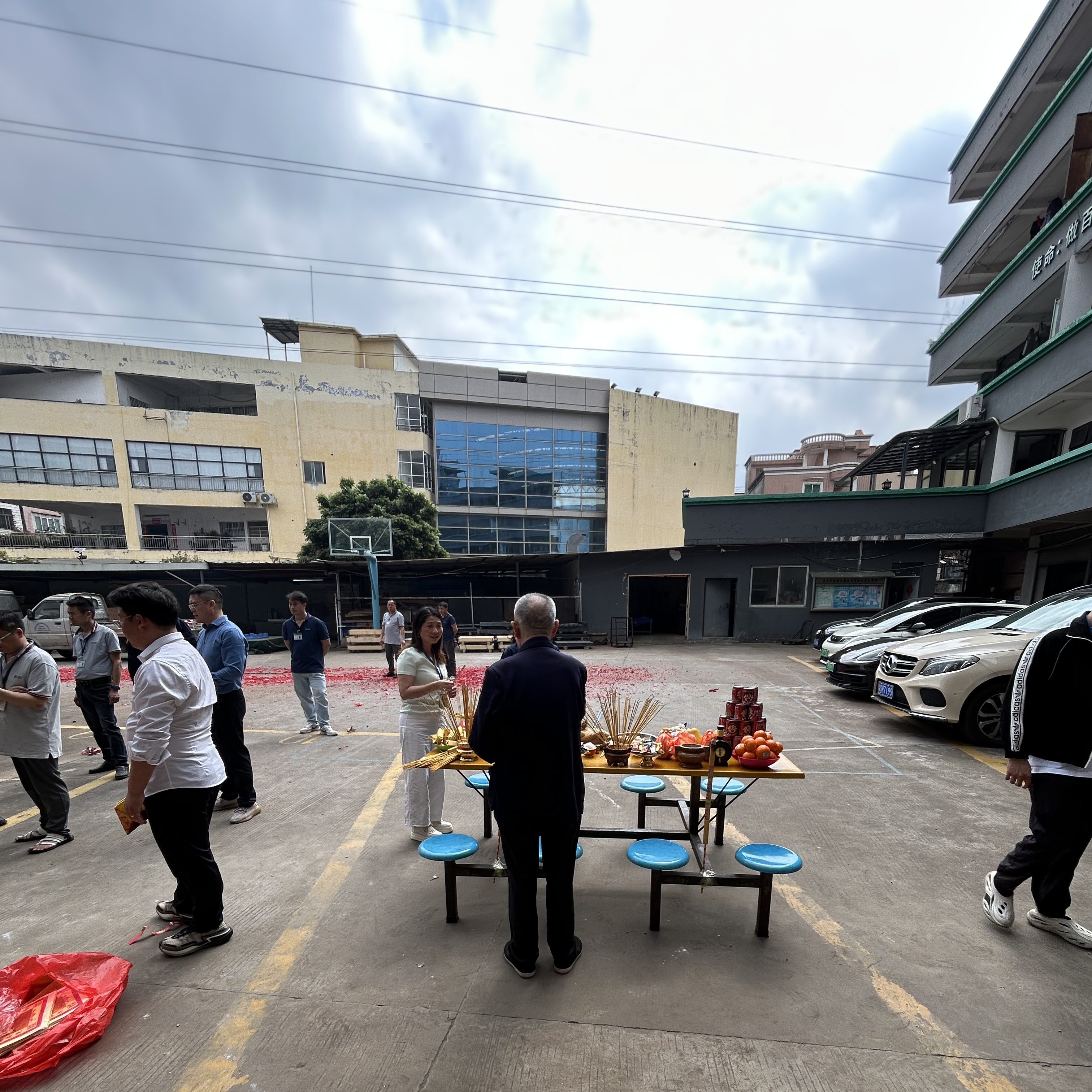 Person standing in a factory with machinery in the background