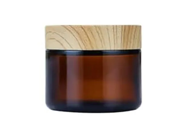 custom cosmetic jars in amber glass with a wood-look cap
