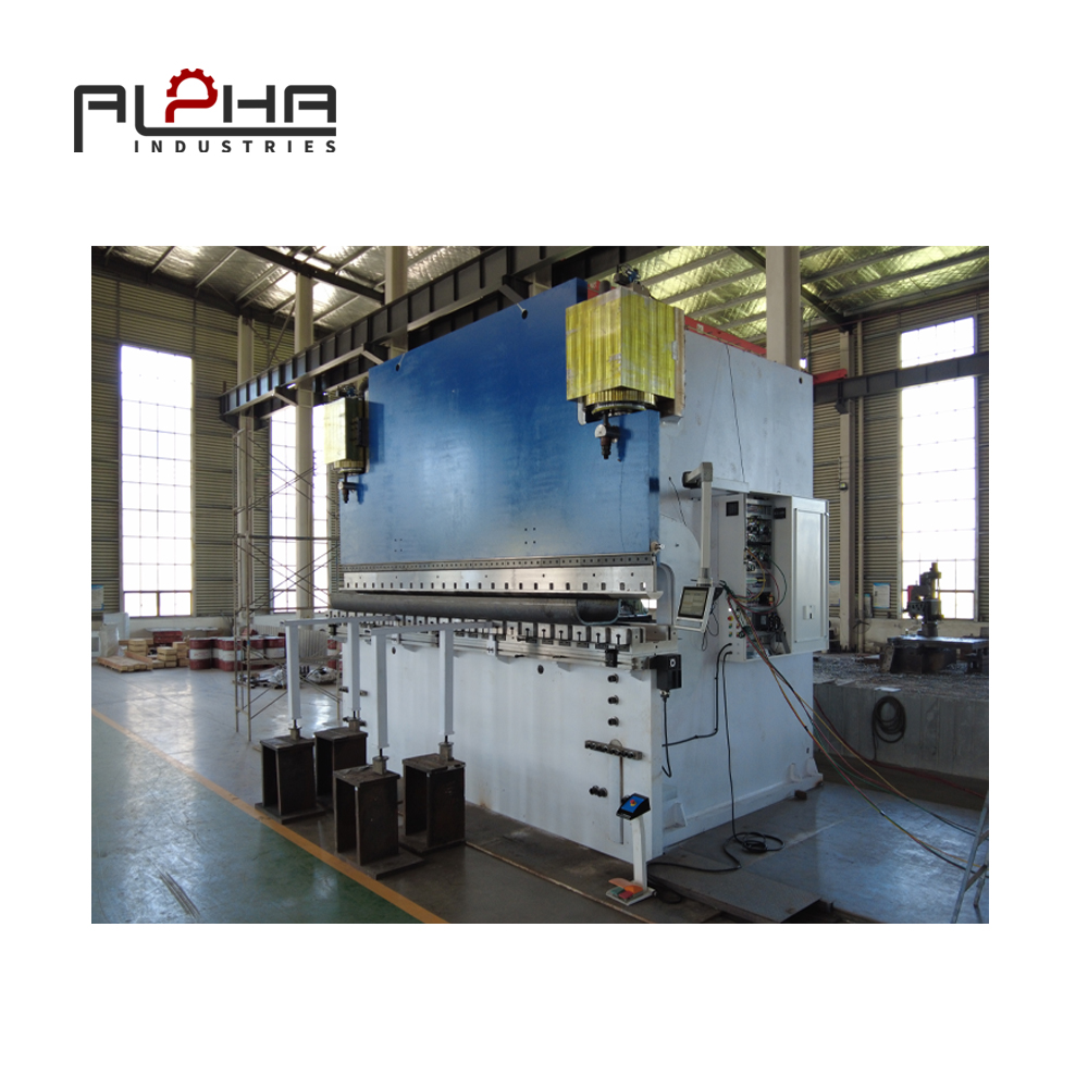 Person standing in a factory with machinery in the background