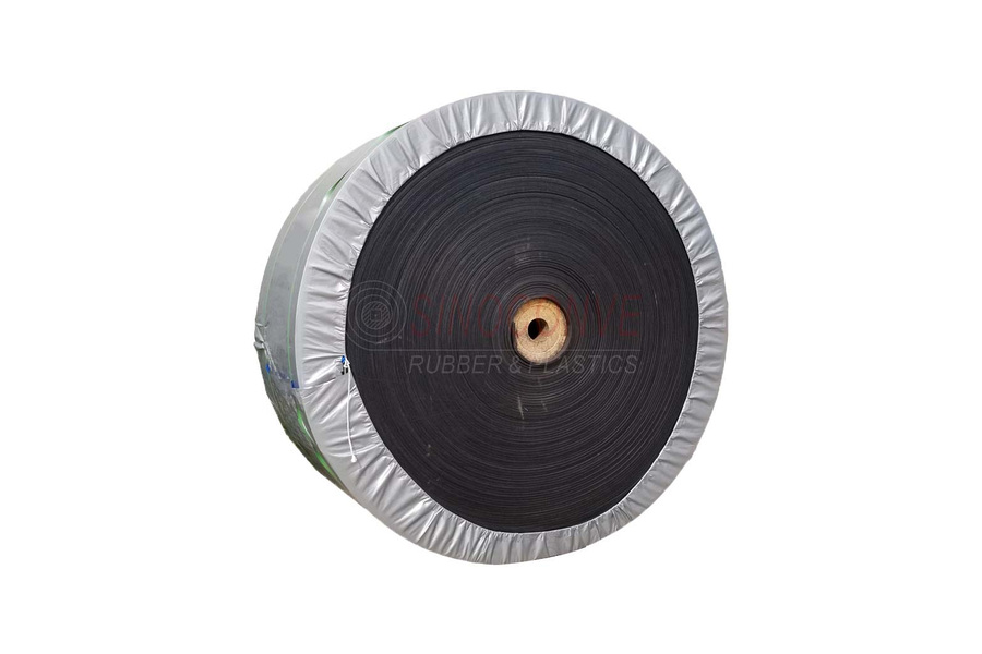 Rolled rubber conveyor belt with protective edge wrapping prepared for handling and shipment