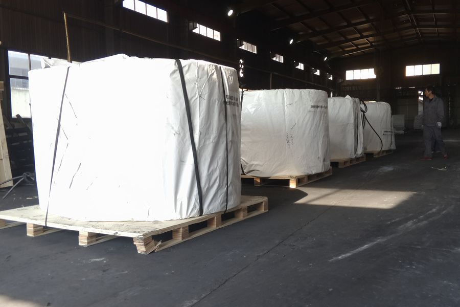 Packed conveyor belt rolls on pallets prepared for shipment