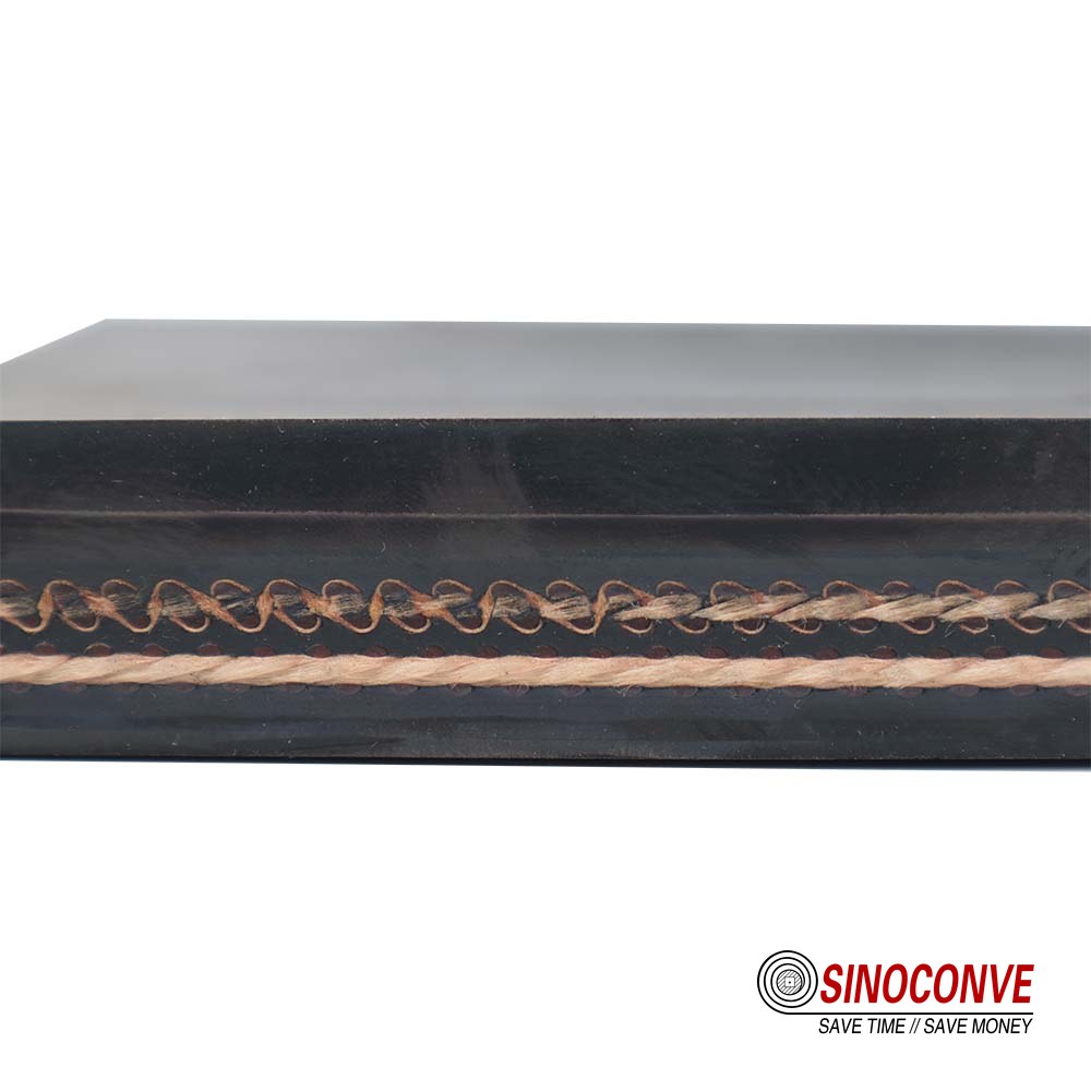 EP rubber conveyor belt roll and cut belt cross-section showing EP fabric plies and cover layers at a manufacturing plant