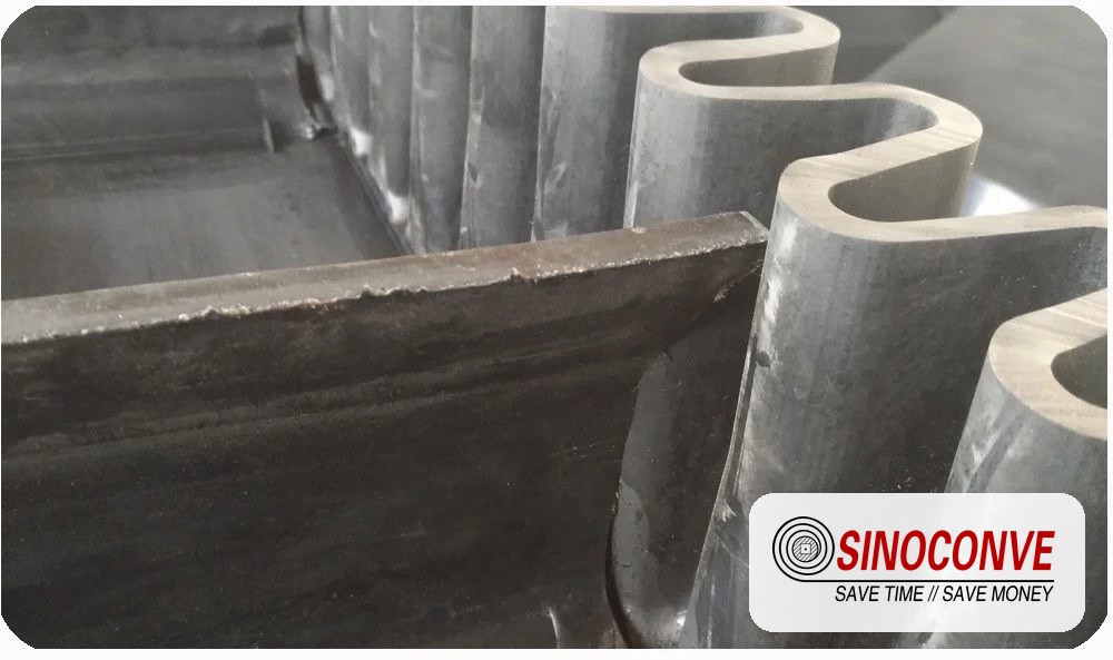corrugated sidewall and cleats on a steep angle conveyor belt base belt before assembly