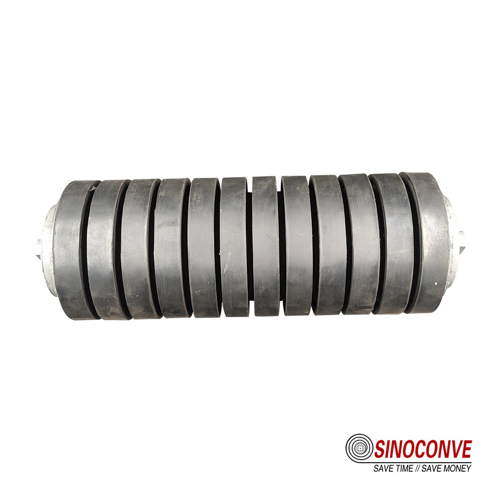 Self-cleaning spiral rollers supporting a return strand as part of conveyor belt cleaning practice
