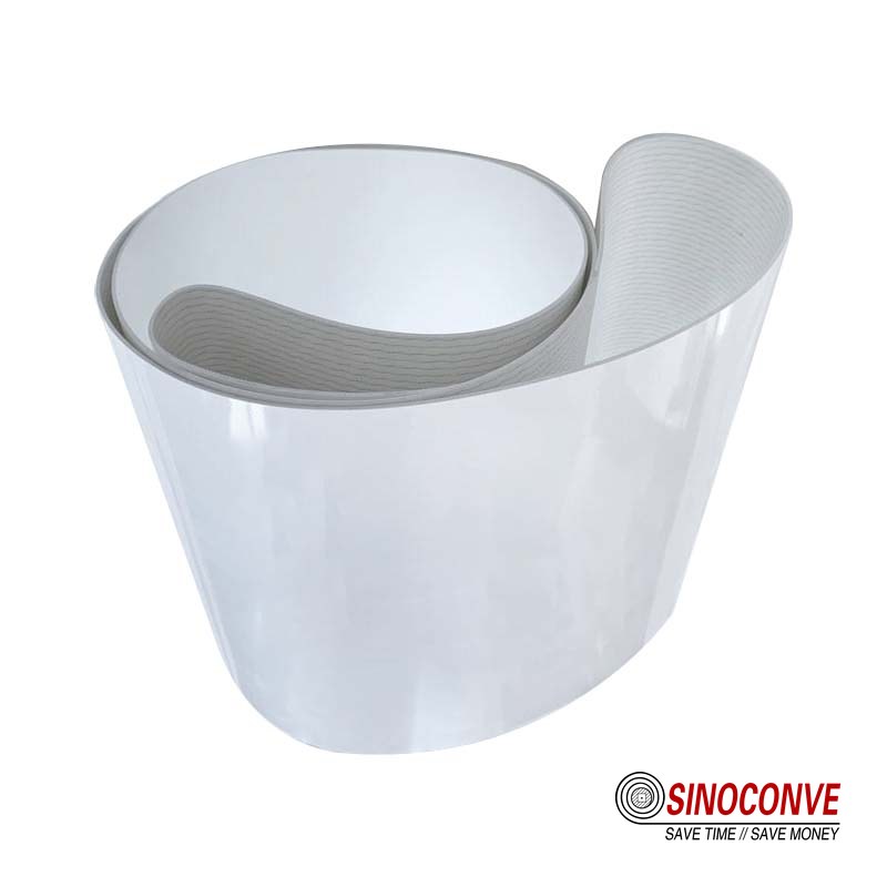 White food grade PVC conveyor belt with a wash-down spray bar above the belt
