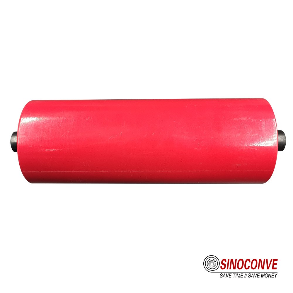 Small track roller batch laid out for incoming inspection beside a calibrated gauge