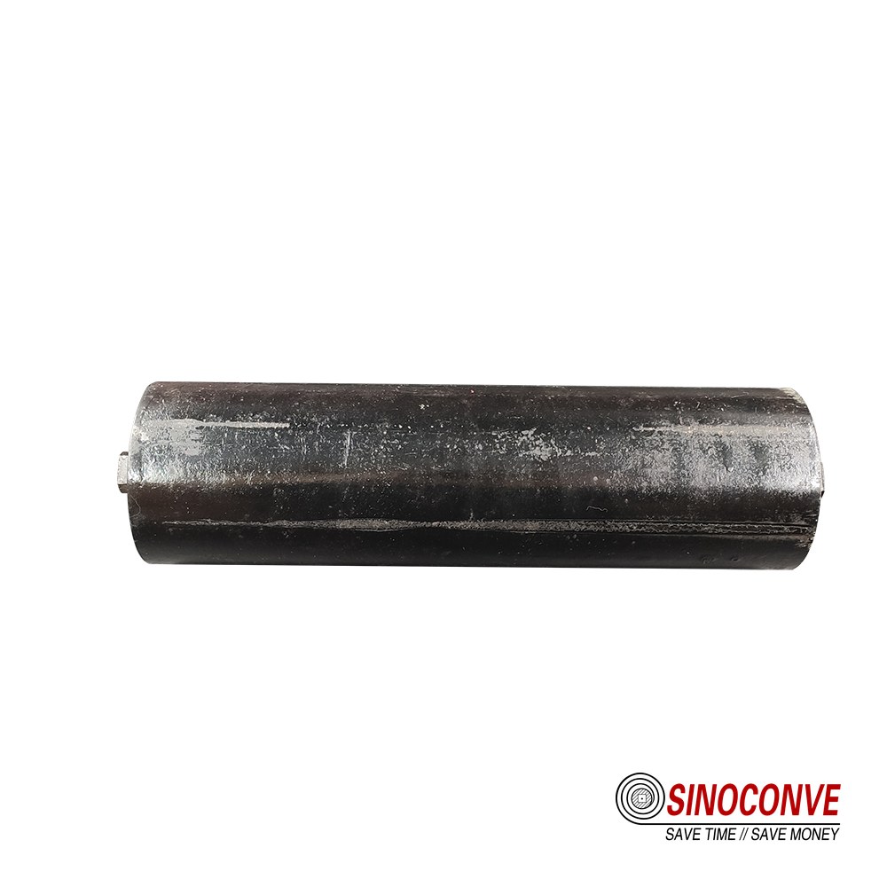 Close-up of a small track roller end cap, shaft and seal on a workshop bench