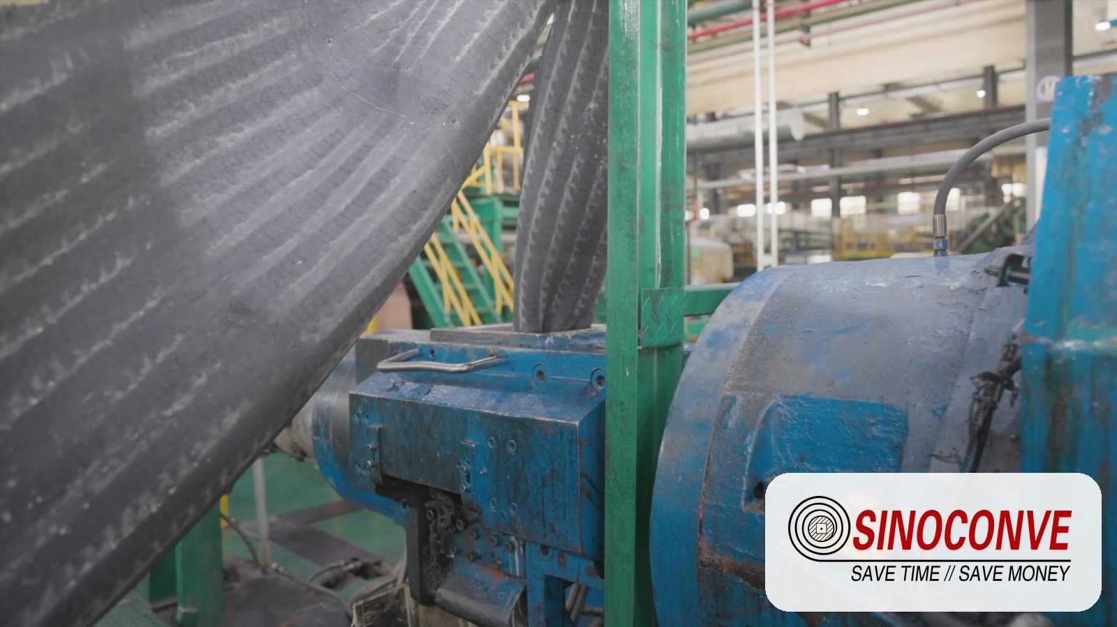 Conveyor belt and roller production area inside the SINOCONVE factory in Ningbo, China, showing finished belts and return-side rollers