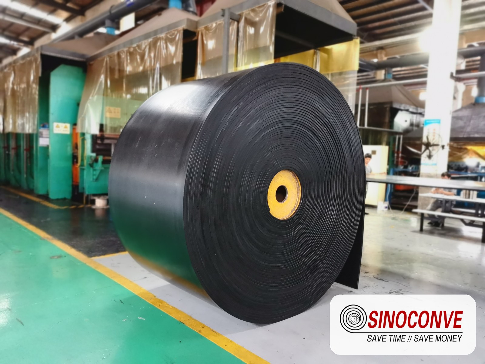 rubber conveyor belt rolls stored in a factory