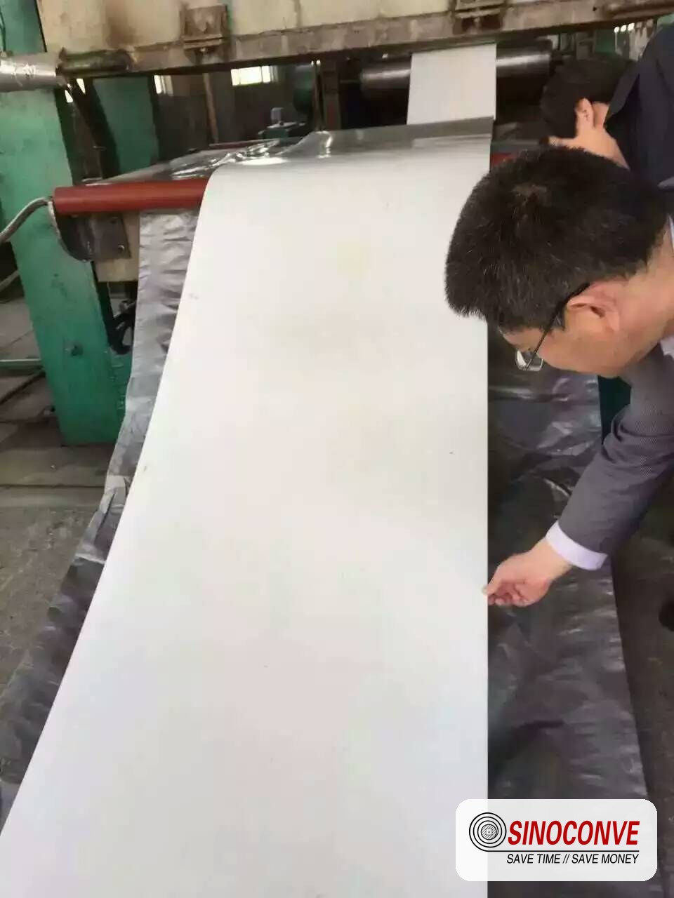 operator unrolling a conveyor belt on site