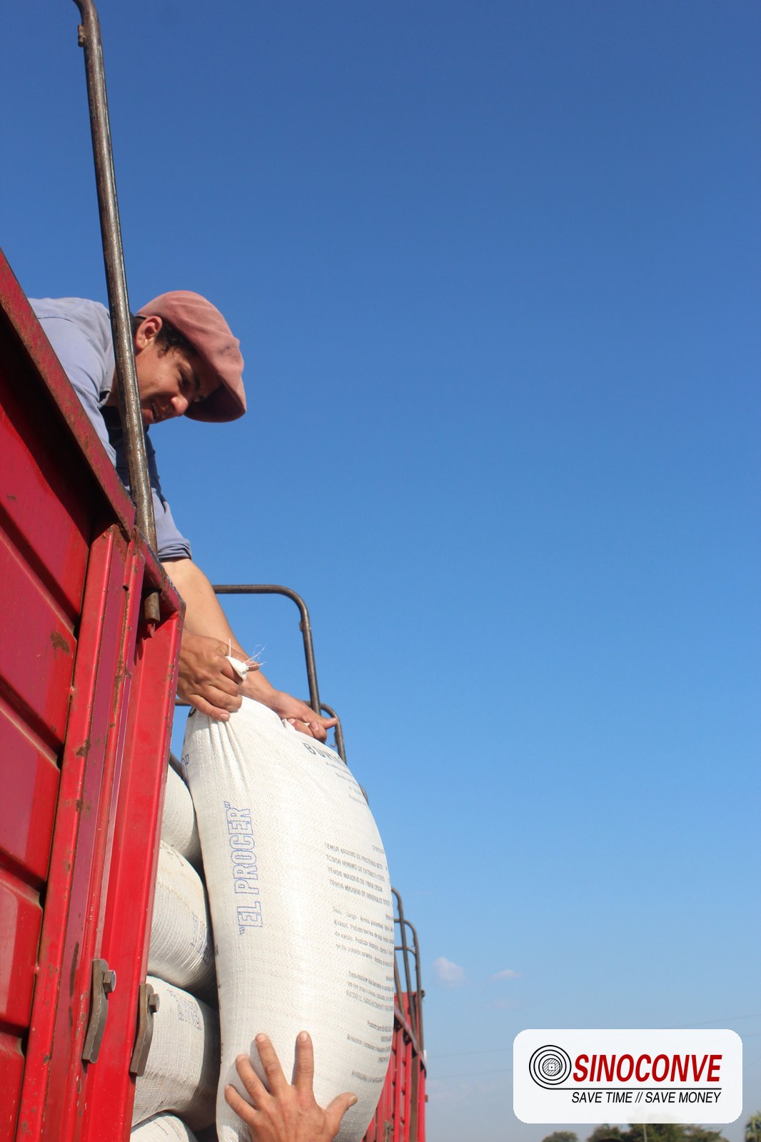 worker handling a heavy conveyor belt section during a splice