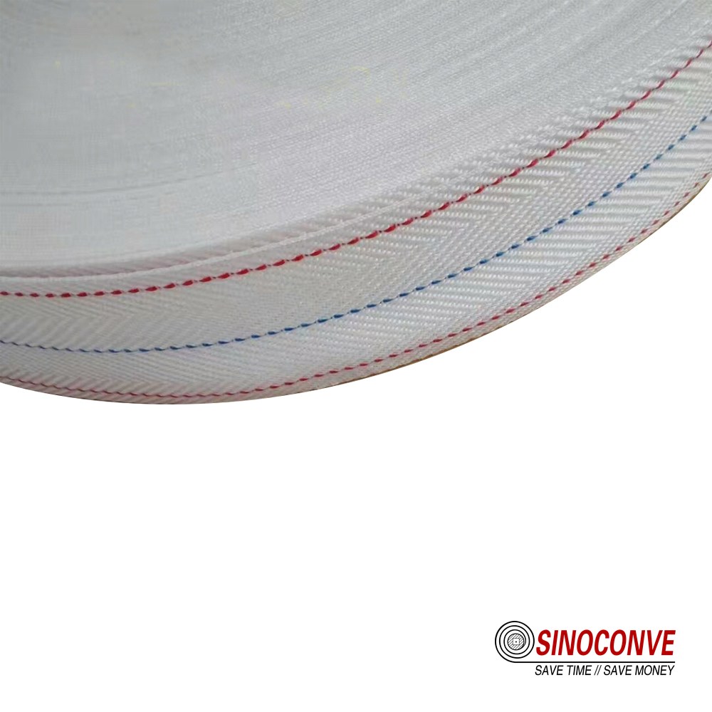 cut edge of a white PVC belt showing fabric reinforcement