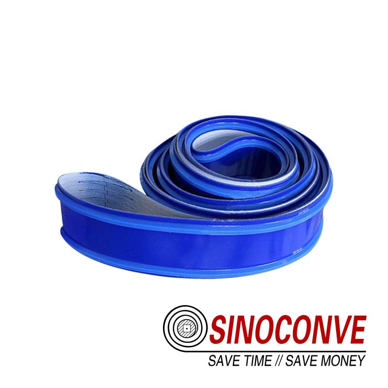 Roll of blue PVC malt conveyor belt coiled in a spiral, ready for dispatch to a malting plant