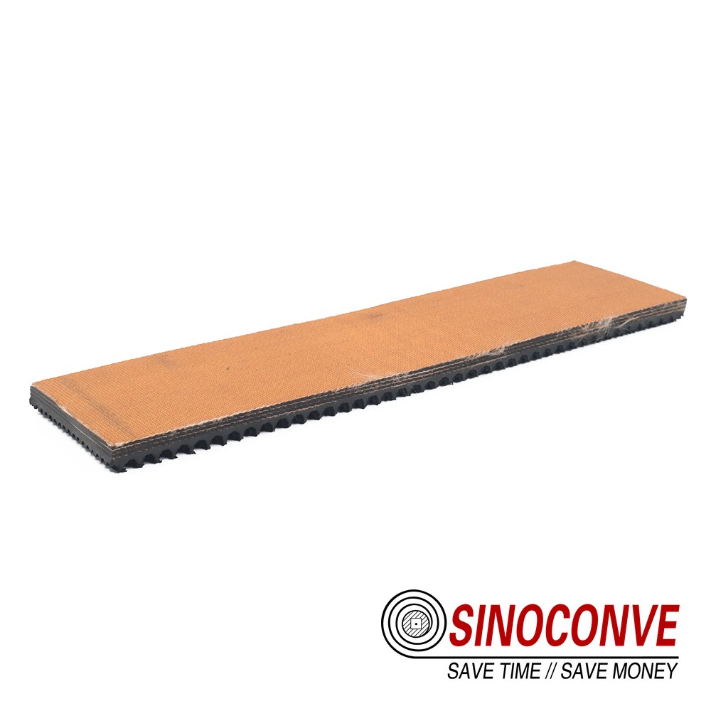 Orange rough-top wood panel conveyor belt sample strip with black toothed underside for panel line conveyors