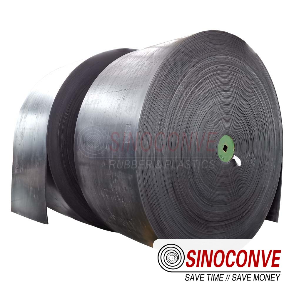Black rubber lime conveyor belt roll photographed on a white background before dispatch to a kiln discharge line