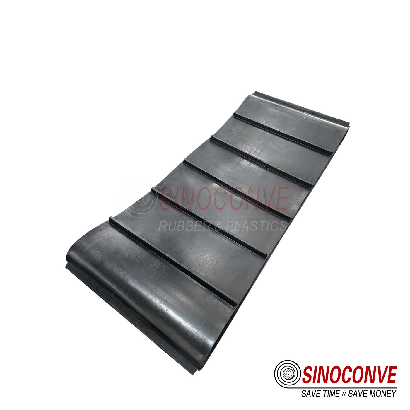 Black rubber conveyor belt section with raised cross cleats used at a lime transfer point