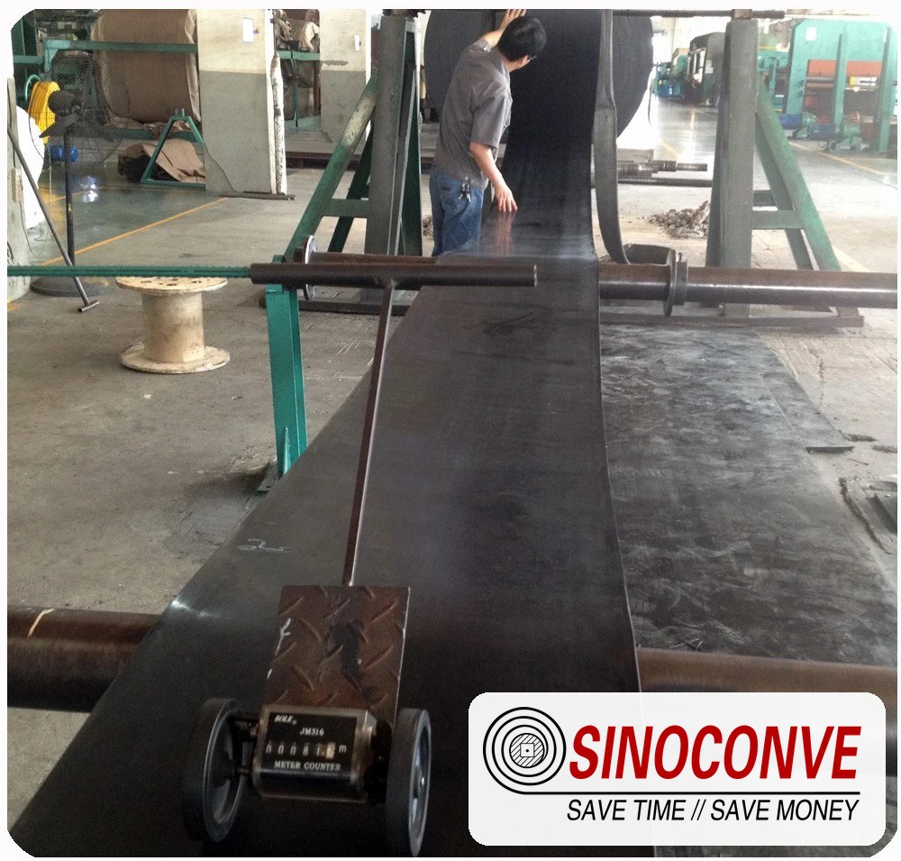 Black belt running through a measuring station for a grain elevator conveyor belt